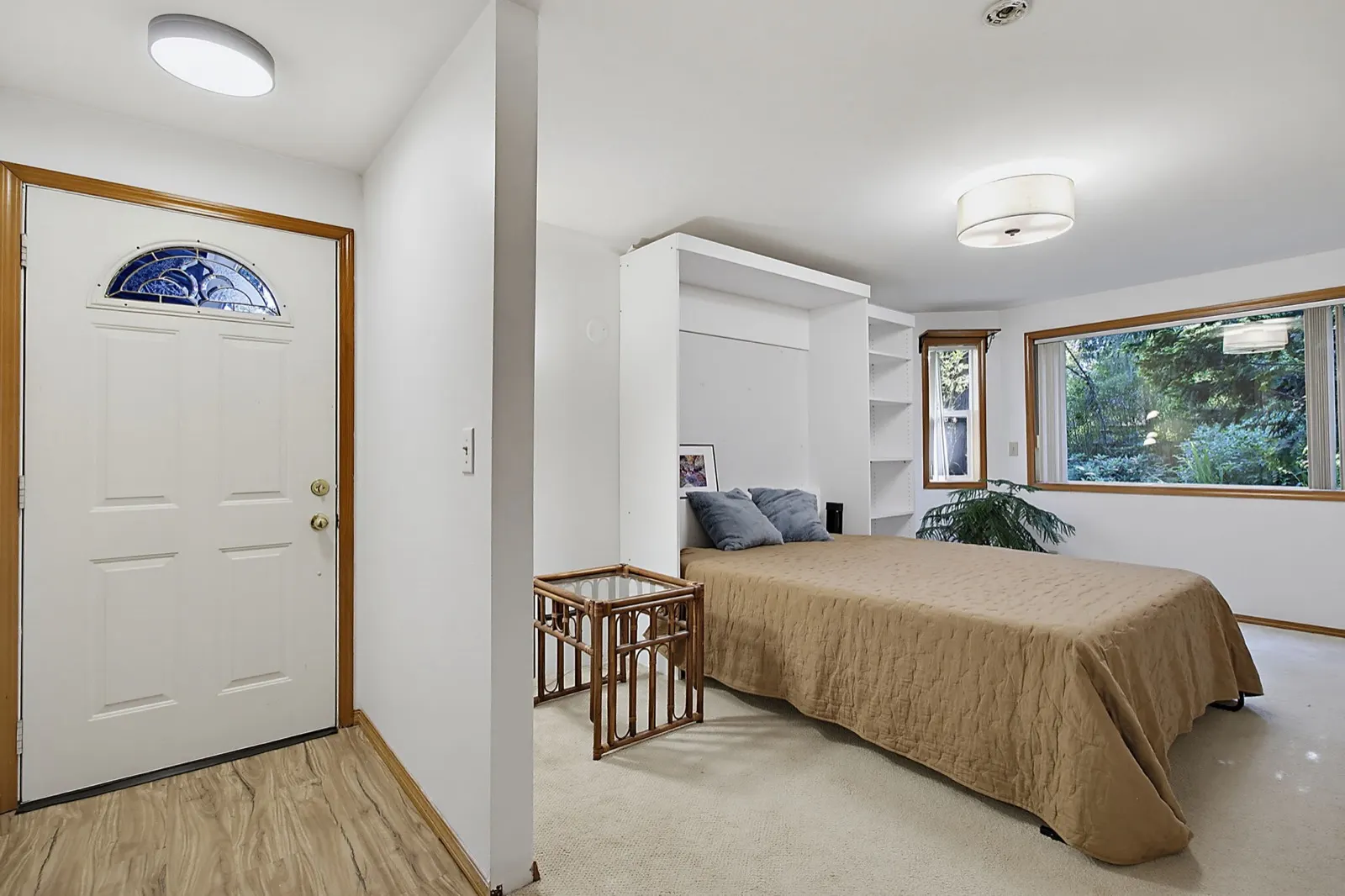 Bedroom with exterior door and built-in shelving in the Kent home